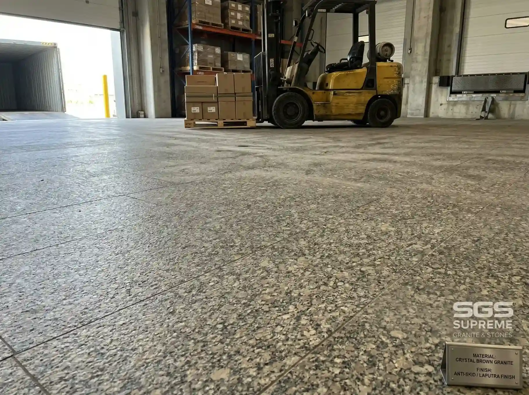 Crystal brown granite flooring in warehouse with forklift, durable anti-skid granite suitable for heavy load industrial applications